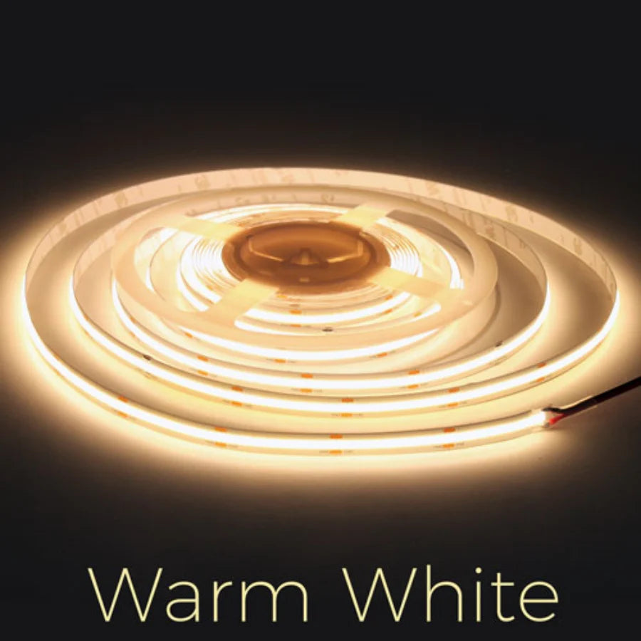 Roll of warm white LED strip light on a dark background at fliptoled
