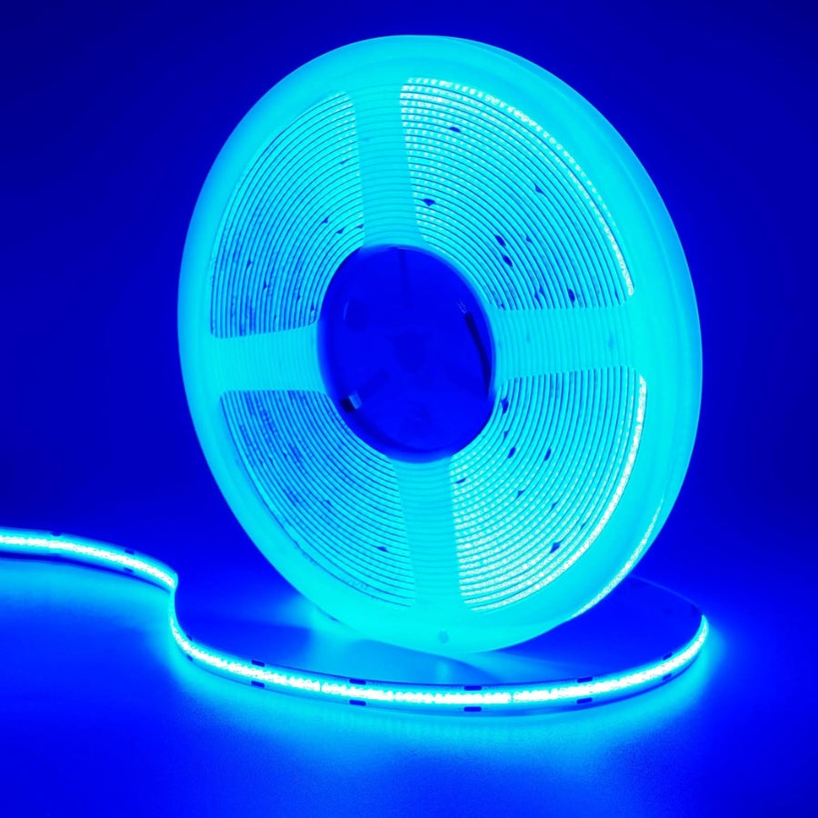 Spool of blue LED strip light against a blue background. 24V COB LED Strip Light