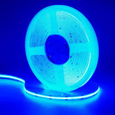 Spool of blue LED strip light against a blue background. 24V COB LED Strip Light