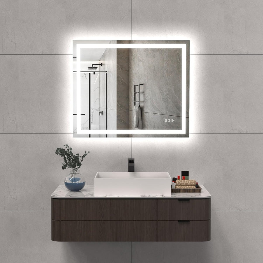 Bathroom vanity with illuminated mirror against a tiled wall