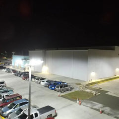 Parking lot with cars and a building at night, commercial-grade led parking lot lights at fliptoled