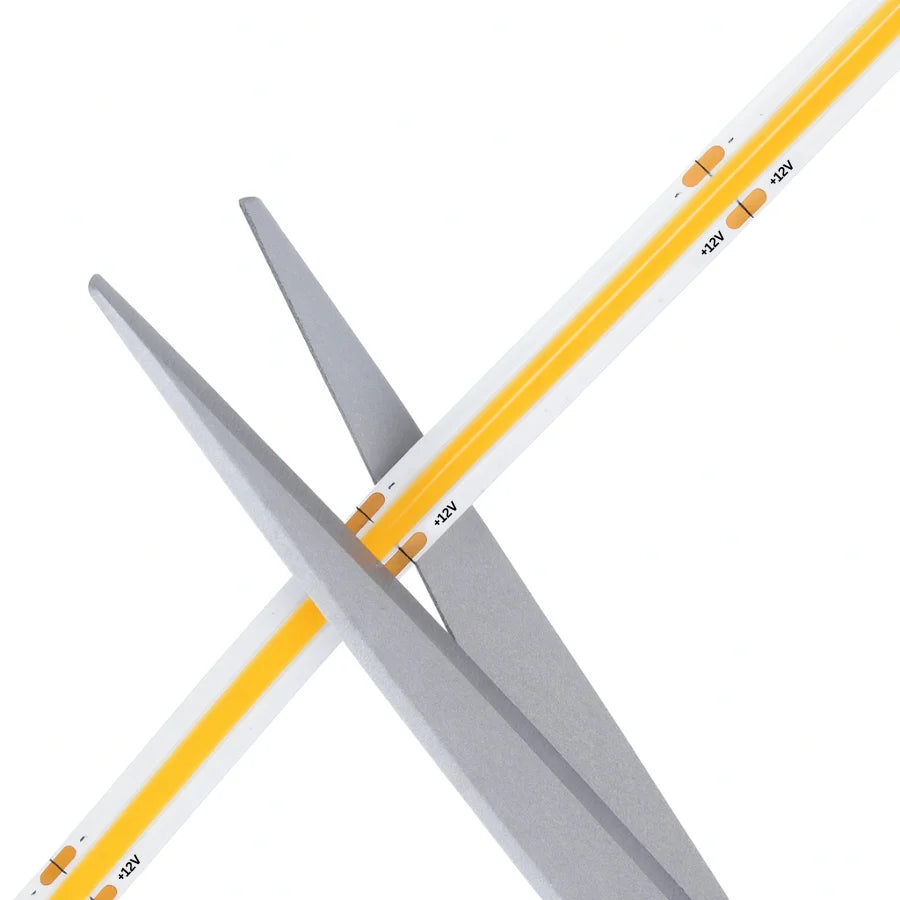 Two crossed drumsticks with white shafts and yellow tips on a white background