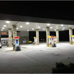 Gas station at night with illuminated pumps and canopy