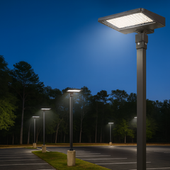 Street lights illuminating a parking lot at night with trees in the background