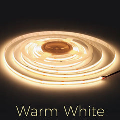 Roll of warm white LED strip light on a dark background at fliptoled