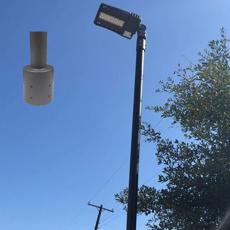 Street light pole with attached light fixture against a clear blue sky