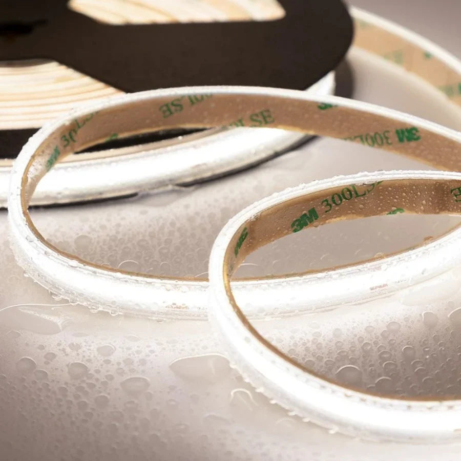 Close-up of a roll of 3M tape with adhesive on a textured surface.