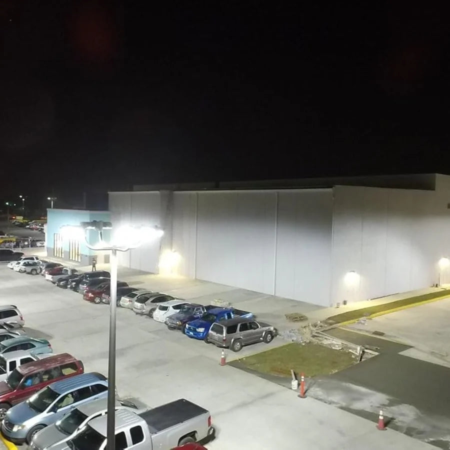 Parking lot with cars and a building at night, commercial-grade led parking lot lights at fliptoled