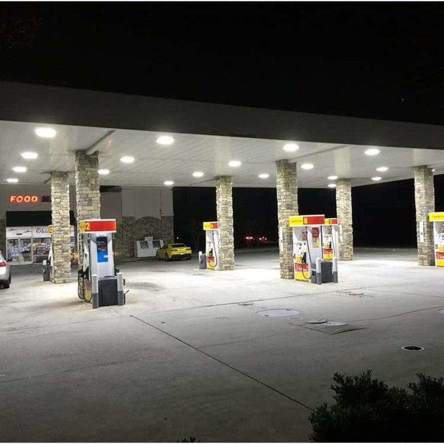 Gas station at night with illuminated pumps and canopy